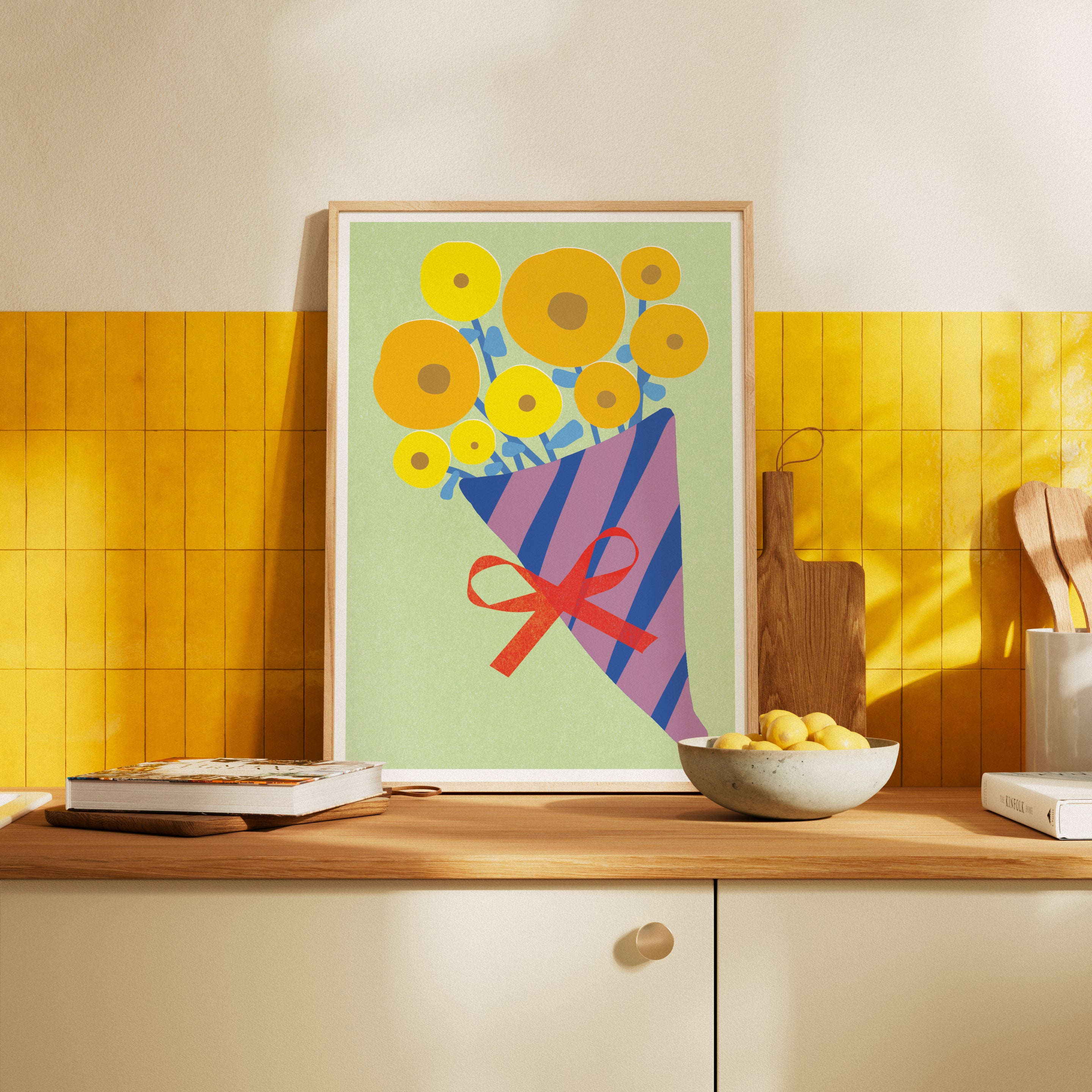 Colorful floral print on a kitchen counter with yellow tiles and a bowl of lemons.
