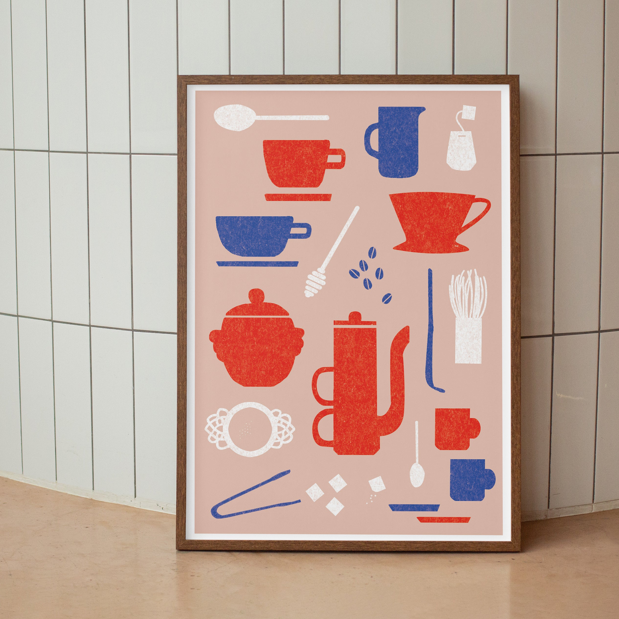 Framed artwork with kitchen-themed design on a tiled wall.