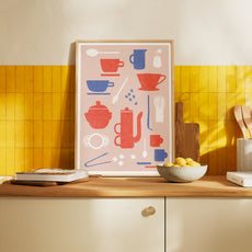 Colorful coffee and tea themed kitchen wall art on a yellow tiled wall with wooden cabinets.
