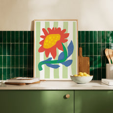 Printable sunflower art hanging in a sunny, modern kitchen with green tiles and wooden accessories