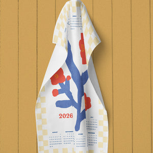 Towel with a design and calendar text hanging on a wooden wall