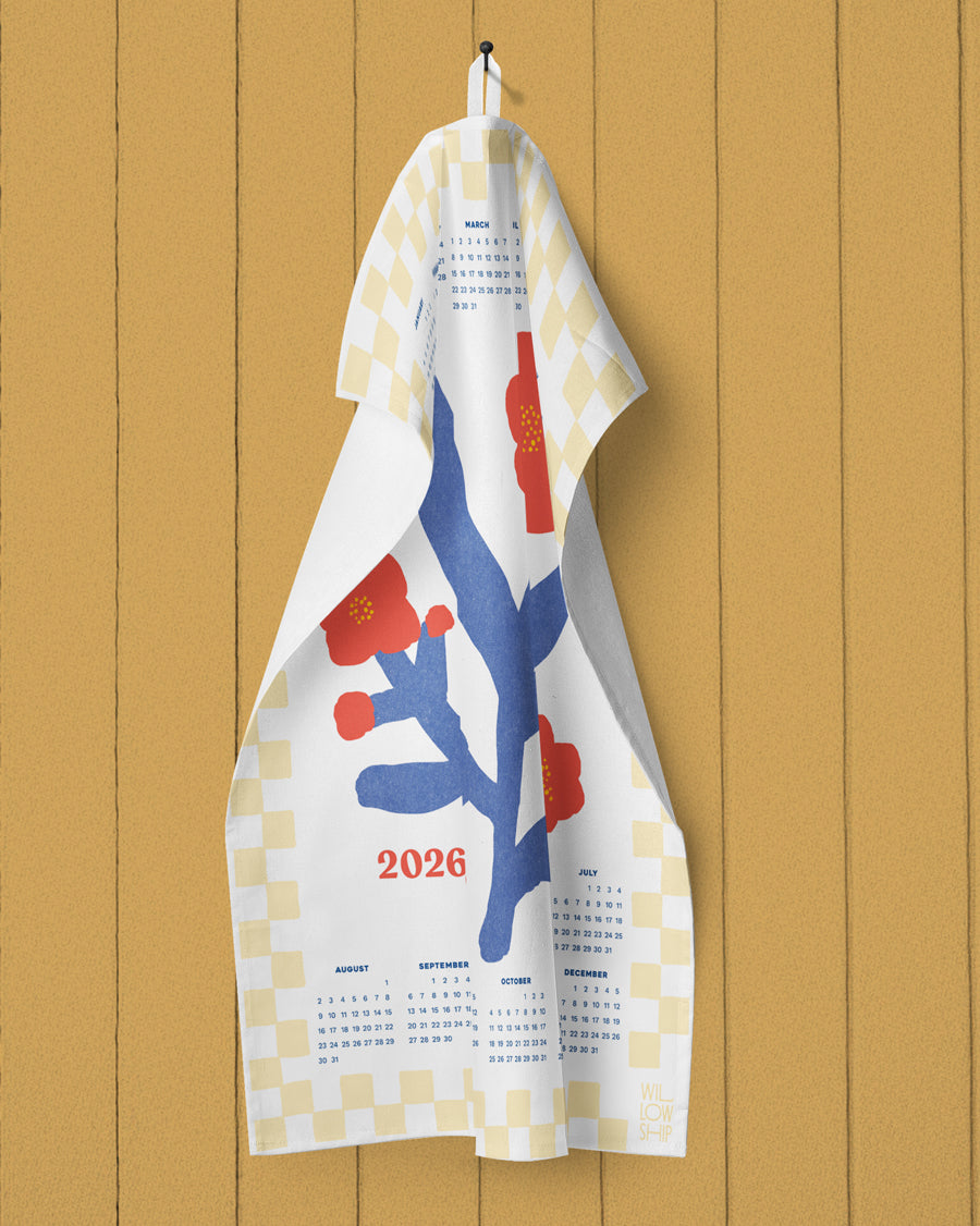 Towel with a design and calendar text hanging on a wooden wall