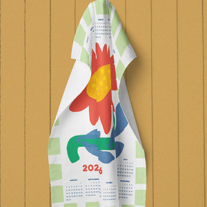 Colorful towel with a design and calendar on a wooden background