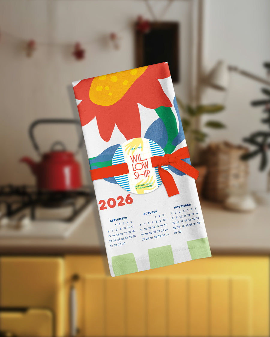 Folded tea towel with green stripes, tied for gifting