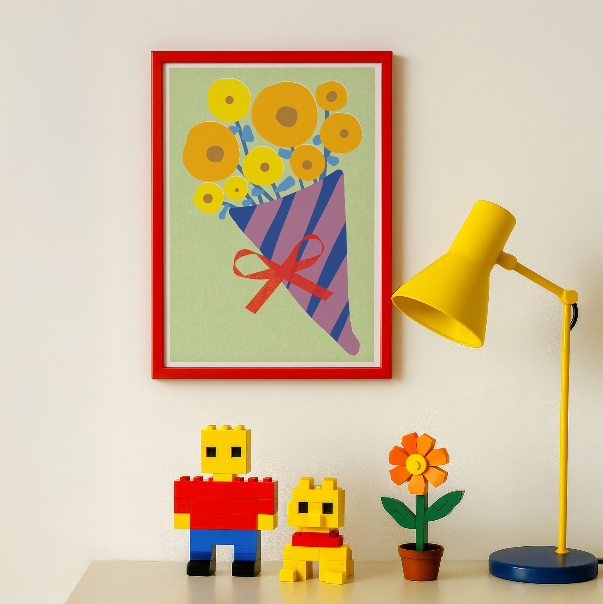 Colorful framed artwork of flowers, yellow lamp, and toy figures on a white wall.