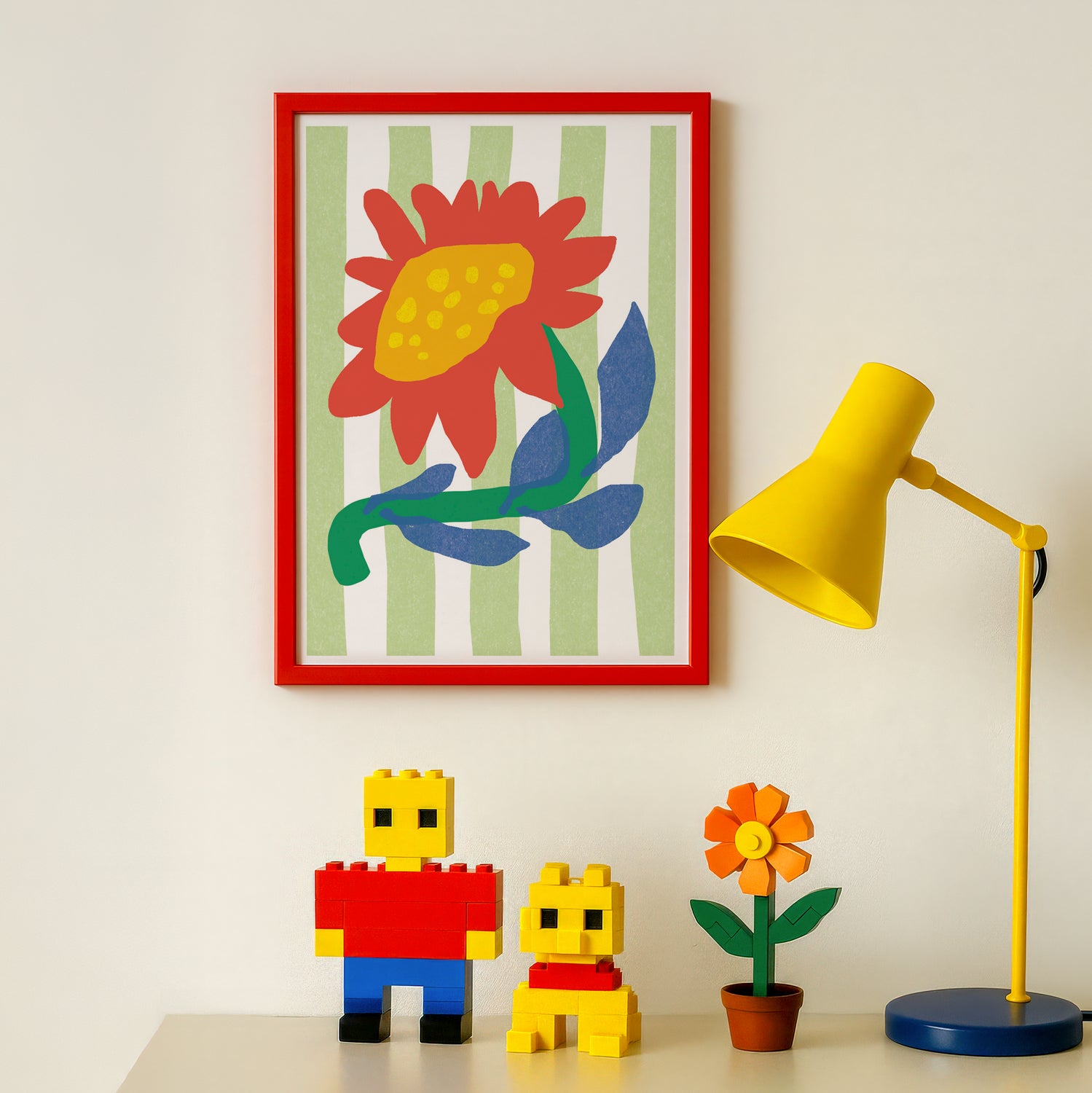 Colorful flower poster with a red frame, yellow lamp, and toy figures on a white surface.