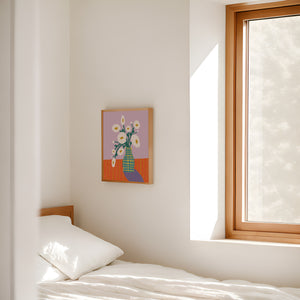 Minimalist bedroom with a bed, window, and framed artwork on the wall.