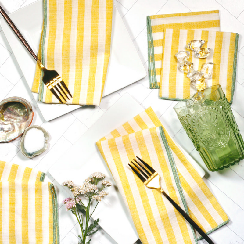 Cabana Citron striped napkins in summer table setting with drinks – yellow and cream cloth napkins with mint edge